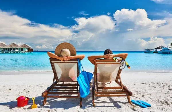 Depositphotos 354422918 stock photo couple sun beds tropical beach