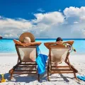 Depositphotos 354422918 stock photo couple sun beds tropical beach